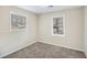 Bedroom featuring neutral-toned walls, a window, fresh carpeting, and decorative wainscoting at 6510 Connell Rd, Atlanta, GA 30349