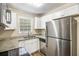 Efficient kitchen has stainless steel appliances, granite counters, and white cabinets at 6510 Connell Rd, Atlanta, GA 30349