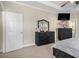 This main bedroom features matching, mirrored dressers and a tray ceiling with ceiling fan at 113 Glenmore Ln, Mcdonough, GA 30253