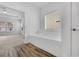 Modern bathroom with a large tub, wood look floors, and a window letting in natural light at 2239 Chestnut Pass, Decatur, GA 30033