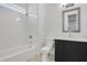 Modern bathroom featuring a shower over tub, gray vanity, and subway tile walls at 2239 Chestnut Pass, Decatur, GA 30033