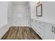Bright bathroom with white cabinets, wood-look tile floors, and glass shower with a bench at 2239 Chestnut Pass, Decatur, GA 30033