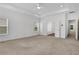 Bright bedroom with neutral carpet, recessed lights, tray ceiling, and a doorway to a bathroom at 2239 Chestnut Pass, Decatur, GA 30033