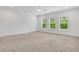 Spacious bedroom with neutral carpet, recessed lights, and three windows offering natural light at 2239 Chestnut Pass, Decatur, GA 30033