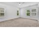 Bright bedroom featuring carpet flooring, large windows, and neutral walls at 2239 Chestnut Pass, Decatur, GA 30033