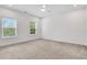 Bedroom with carpet flooring, ceiling fan, and large windows overlooking the yard at 2239 Chestnut Pass, Decatur, GA 30033