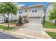 Modern two-story home featuring a spacious driveway, attached garage, manicured lawn, and attractive curb appeal at 2239 Chestnut Pass, Decatur, GA 30033
