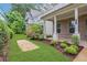 Well-manicured front yard with lush green grass, decorative mulch beds, and vibrant flowers at 2239 Chestnut Pass, Decatur, GA 30033