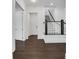 Hallway with hardwood floors, white walls, and staircase with decorative balusters at 2239 Chestnut Pass, Decatur, GA 30033
