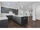 Modern kitchen featuring sleek gray cabinets, stainless steel appliances, a large center island, and hardwood floors at 2239 Chestnut Pass, Decatur, GA 30033