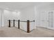 Upstairs landing featuring wood and white balustrade and neutral carpet on the floor at 2239 Chestnut Pass, Decatur, GA 30033