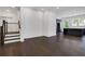 Open concept living space with hardwood floors, staircase, and view of the modern kitchen with gray cabinetry at 2239 Chestnut Pass, Decatur, GA 30033