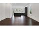 Spacious living area with hardwood floors and open layout to the modern kitchen with gray cabinetry at 2239 Chestnut Pass, Decatur, GA 30033