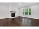 Cozy living room featuring hardwood floors, a modern fireplace, recessed lighting, and large windows for natural light at 2239 Chestnut Pass, Decatur, GA 30033