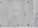 Modern shower with white tile, glass doors, and a built in bench at 2239 Chestnut Pass, Decatur, GA 30033