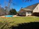 Spacious backyard with a large in-ground pool, patio area, and green grass at 3416 Haddon Hall Ct, Buford, GA 30519