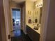Bathroom featuring double sinks, gray cabinets and an adjoining room with a window at 3416 Haddon Hall Ct, Buford, GA 30519