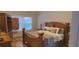 Primary bedroom with hardwood floors, a large window, and elegant furnishings at 3416 Haddon Hall Ct, Buford, GA 30519