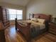 Primary bedroom featuring hardwood floors, a large window, and a spacious layout at 3416 Haddon Hall Ct, Buford, GA 30519