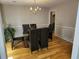 Well-lit dining room with hardwood floors, modern chairs, and chandelier at 3416 Haddon Hall Ct, Buford, GA 30519