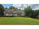 Charming two-story brick home with well-manicured lawn and inviting front porch at 3416 Haddon Hall Ct, Buford, GA 30519