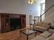Living room with tall ceiling, wooden floors, and large entertainment center at 3416 Haddon Hall Ct, Buford, GA 30519