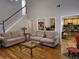 Cozy living room with staircase, sofas, and view to the kitchen at 3416 Haddon Hall Ct, Buford, GA 30519