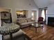 Relaxing living room with an open view of the kitchen and fireplace at 3416 Haddon Hall Ct, Buford, GA 30519