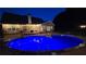 Backyard pool at night with exterior house lighting and a diving board at 3416 Haddon Hall Ct, Buford, GA 30519