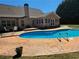 Backyard swimming pool featuring concrete patio and diving board at 3416 Haddon Hall Ct, Buford, GA 30519