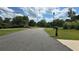 Street view with manicured lawn and mature trees on a sunny, partially cloudy day at 3416 Haddon Hall Ct, Buford, GA 30519