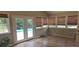 Bright sunroom with tile floors, large windows, and access to a pool area at 3416 Haddon Hall Ct, Buford, GA 30519