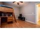 Bedroom with wood flooring featuring a loft bed and media center at 7153 Tara Dr, Villa Rica, GA 30180