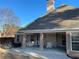 Relaxing back porch with brick columns, ceiling fan, and seating perfect for outdoor entertaining at 828 Cedar Stream Ct, Loganville, GA 30052