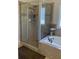 Bathroom featuring glass shower and a soaking tub at 828 Cedar Stream Ct, Loganville, GA 30052