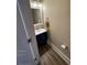 Powder room with hardwood floors and a vanity sink at 828 Cedar Stream Ct, Loganville, GA 30052