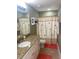 Bathroom with granite counters, decorative shower curtain and tiled floors at 828 Cedar Stream Ct, Loganville, GA 30052