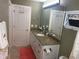 Bathroom featuring granite counter tops, white cabinets and a decorative vanity mirror at 828 Cedar Stream Ct, Loganville, GA 30052