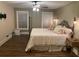 Spacious bedroom with ceiling fan, hardwood floors, and large windows with coverings at 828 Cedar Stream Ct, Loganville, GA 30052