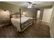 Well-lit bedroom featuring a decorative metal bed frame and dark hardwood floors at 828 Cedar Stream Ct, Loganville, GA 30052