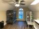 Bonus room with hardwood floors, ceiling fan, window and two large bird cages at 828 Cedar Stream Ct, Loganville, GA 30052