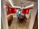 Formal dining room with red walls, white trim, a tray ceiling with recessed lighting, and wood-look floors at 828 Cedar Stream Ct, Loganville, GA 30052