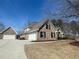 Charming brick home with attached garages and manicured front yard at 828 Cedar Stream Ct, Loganville, GA 30052