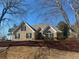 Charming brick home featuring well-manicured landscaping and a symmetrical, eye-catching facade at 828 Cedar Stream Ct, Loganville, GA 30052
