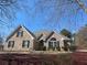 Charming brick home featuring well-manicured landscaping and a symmetrical, eye-catching facade at 828 Cedar Stream Ct, Loganville, GA 30052