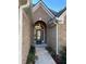 Inviting front entrance with decorative glass door and brick archway with beautiful sidelights at 828 Cedar Stream Ct, Loganville, GA 30052