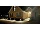 Beautiful brick home with landscaped walkway illuminated with landscape lighting at 828 Cedar Stream Ct, Loganville, GA 30052