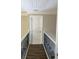Hallway with hardwood floors, railings, and a door at the end at 828 Cedar Stream Ct, Loganville, GA 30052