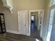 Hallway with doors leading to various rooms and a light-filled entryway at 828 Cedar Stream Ct, Loganville, GA 30052