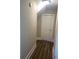 Hallway with hardwood floors leading to a door at 828 Cedar Stream Ct, Loganville, GA 30052